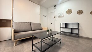 Een moderne woonkamer met een bank, een salontafel en een boekenkast.