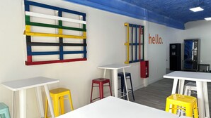 A children's playroom with colorful storage units, tables, and stools. - Agi Gloria Rooms 304 Hostel for rent in Roses Girona. (Roses)