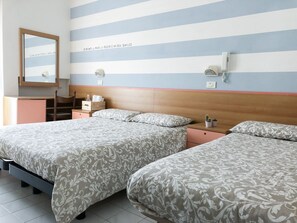 A hotel room with two beds, a wooden headboard, a small desk, a mirror, and a striped wall. - Alba B&B Appartamenti (Cattolica)