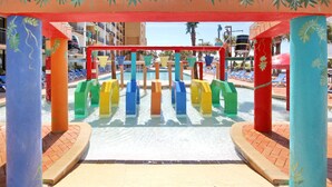 A water play area with colorful structures and a pool in the background. - Family Fun at this Beachside Resort in Myrtle Beach (Myrtle Beach)