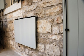 A whiteboard mounted on a stone wall with a metal frame. - Apartment in the historic center (1 floor) (Novigrad)