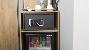 A minibar with a refrigerator, a coffee maker, and a water bottle. - Jurnal Hotel (Istanbul)