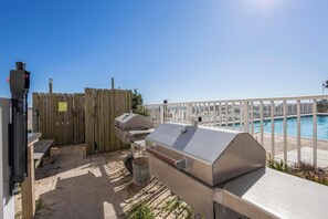 Enjoy al fresco dining and relaxation by the pool, where a barbecue grill and comfortable seating await.
