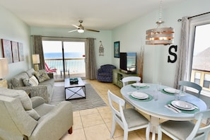 Relax in style with a comfortable sofa, dining table for four, and stunning ocean views from the balcony.