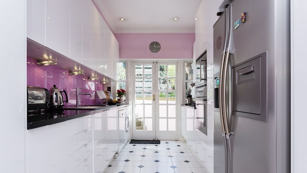 A modern kitchen with white cabinets, a stainless steel refrigerator, and a black and white tiled floor. - The Gallery of Colour, by Veeve (London)