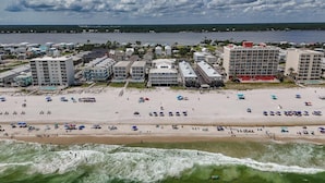 A coastal hotel area with beachfront, ocean waves, and buildings. - Recently refurnished condo directly on the beach! (Gulf Shores)