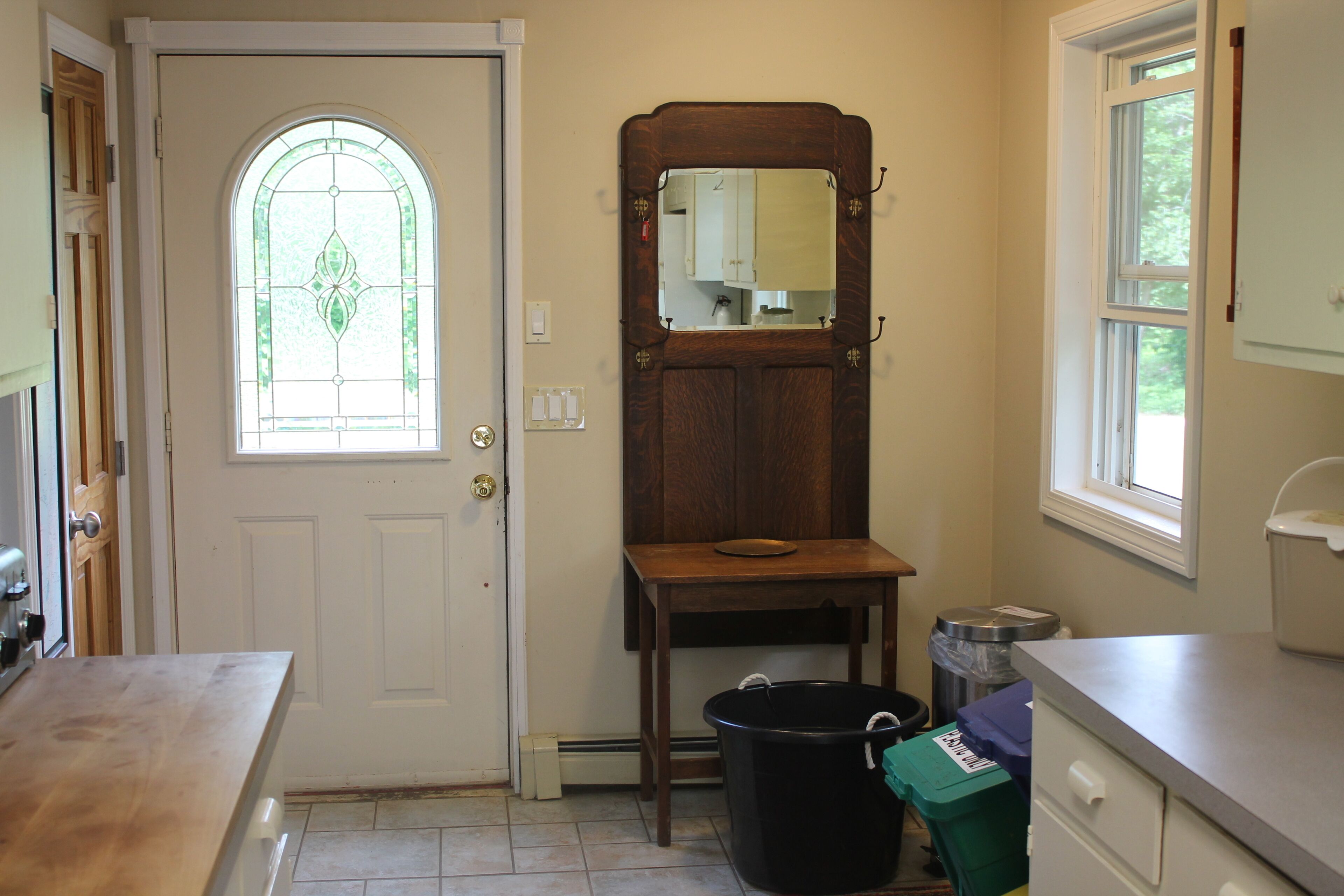 A kitchen with a wooden table, a sink, and a window with a view.