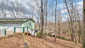 A single-story house with a garage, surrounded by a wooded area. - Starstorm Mountain Apartment
Lakeview deck & hiking trail, near many activities. (Lake Junaluska)