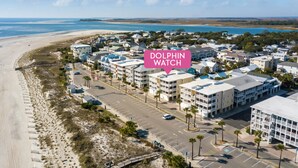 A coastal hotel with multiple buildings, a beach, and a clear sky. - Spacious w/ Fantastic Views, Large Balcony, Walkable Location! (Tybee Island)