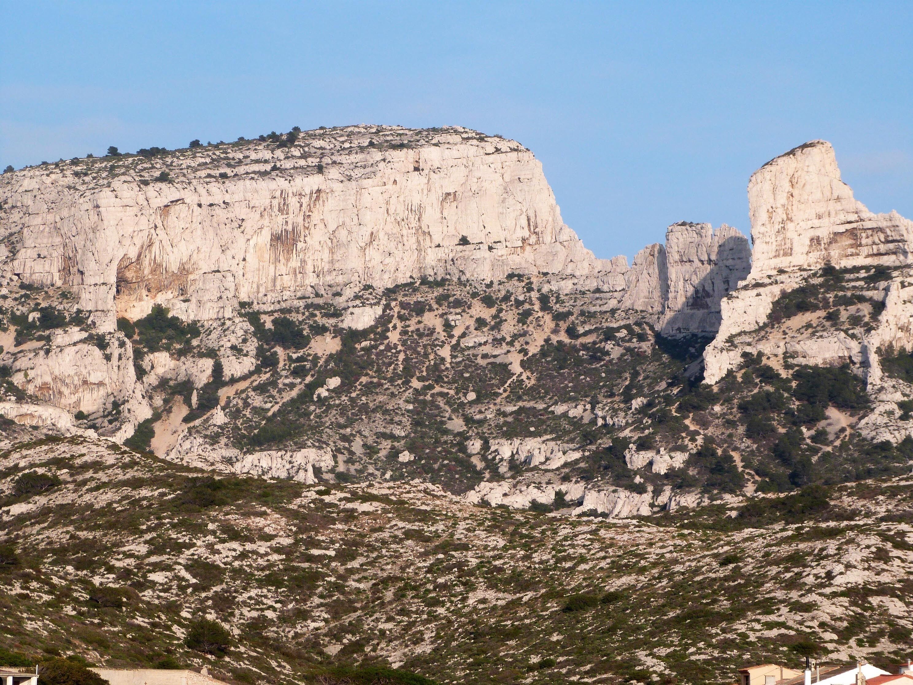 A mountainous landscape with rocky terrain and sparse vegetation.