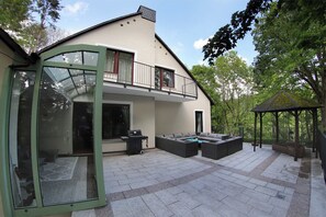 Enjoy outdoor entertaining on the spacious patio with a grill and seating area.