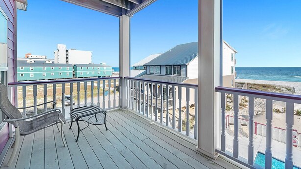 A covered porch with a bench, overlooking a beach with buildings in the background. - Sundancer, East. Beachfront 5BR Pool! PERFECT location. 😎 (Gulf Shores)