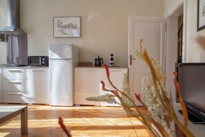 A modern kitchen with a microwave, toaster, and coffee maker.