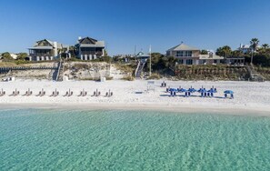 A beachfront property with multiple houses, a sandy beach, and clear turquoise water. - Beach, Cozy for 2, 1Bedroom, 1Bath, 10 min walk to beach (Santa Rosa Beach)
