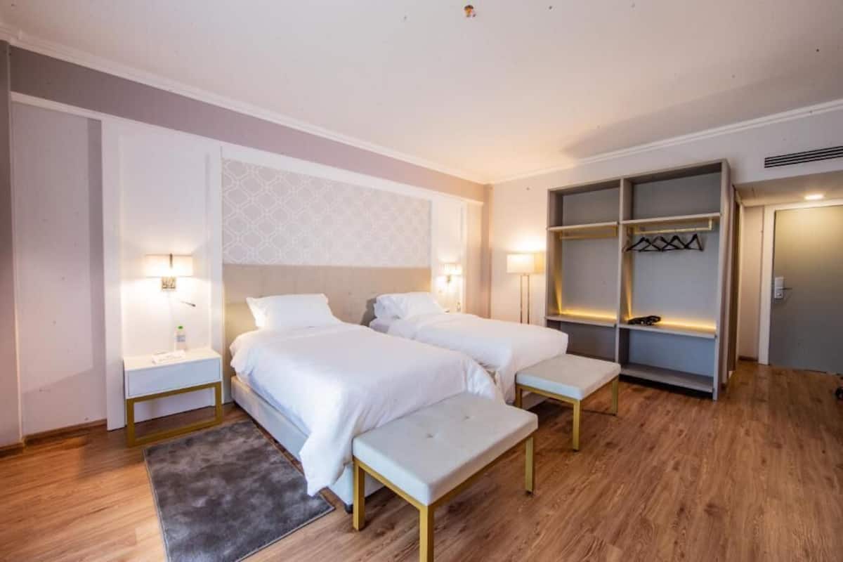 Deluxe Room, 2 Single Beds | Minibar, in-room safe, laptop workspace, iron/ironing board