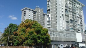 A modern multi-story building with balconies and a flat facade. - Zen Retreat (San Juan)