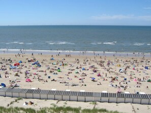 A beach with numerous tents and people.