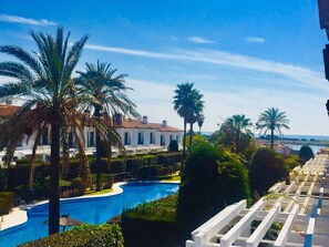 Relax by the pool surrounded by lush greenery and enjoy breathtaking views of the sea.