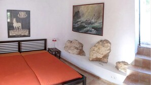 A room with a bed, a framed picture of a horse, and a framed painting of a ship. - Gorgeous Andalusian house in a protected Nature Reserve (Nerja)