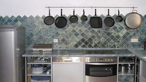 A kitchen with a stainless steel refrigerator, a built-in oven, and a microwave. - Gorgeous Andalusian house in a protected Nature Reserve (Nerja)