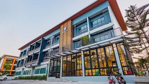 A multi-story hotel with a modern design, featuring balconies and large windows. - Mosstel (Phitsanulok)