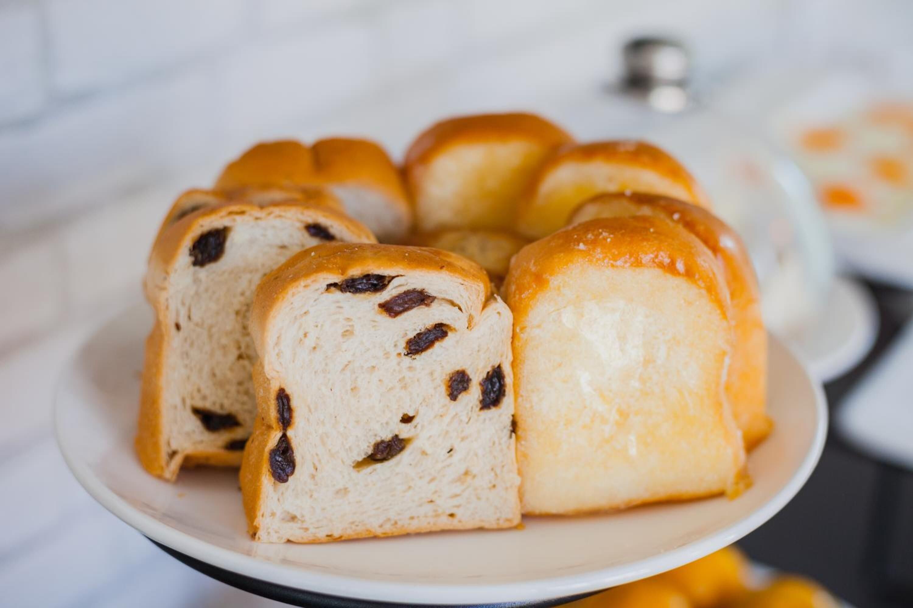 A loaf of bread with raisins on a plate.