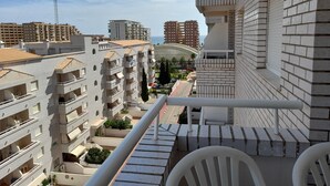 A high-rise residential building with multiple balconies, a clear view of the surrounding area, and a prominent antenna structure. - Perfect views and location (Oropesa)