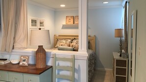 A bedroom with a bed, a dresser, a chair, and a nightstand. - Cozy Studio in Long Beach / EAB (East Atlantic Beach)