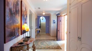 A hallway with a marble floor, a wooden door, and a staircase in the background. - luxury villa for 8 persons with private pool, panoramic views, WIFI (Manilva)