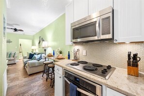 The well-equipped kitchen keeps everything close at hand, with the living area just beyond for an open, connected feel. - Stunning Beach Suite, Heated Pool, Steps to Sand! Clearwater ➠ Beach Suites #105 (Clearwater Beach)