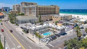 A hotel with multiple buildings, a pool, and a beach view. - Cute beach condo with heated pool, steps to the sand ➠ CBS 204 (Clearwater)