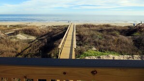 A wooden boardwalk leading to a beach with dunes and a clear sky. - "As Good As It Gets" Beautiful Beach Front House! (Surfside Beach)