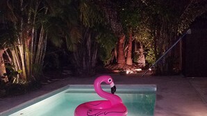 A swimming pool with a pink flamingo float. - "OLD FLORIDA" RIVERSIDE POOL COTTAGE THAT TIME FORGOT (Sebastian)