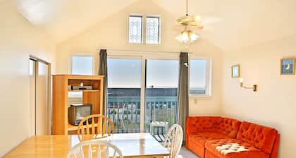 1BR beachfront condo, kitchen, & sea-view balcony