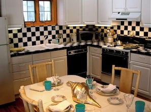 Enjoy cooking and dining in this well-equipped kitchen with a sink, microwave, oven, and dishwasher.