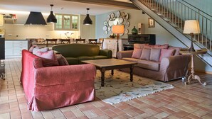 A living room with a sofa, a coffee table, and a staircase.