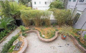 Stunning garden surrounded by a brick border, featuring a mix of shrubs and flowering plants.