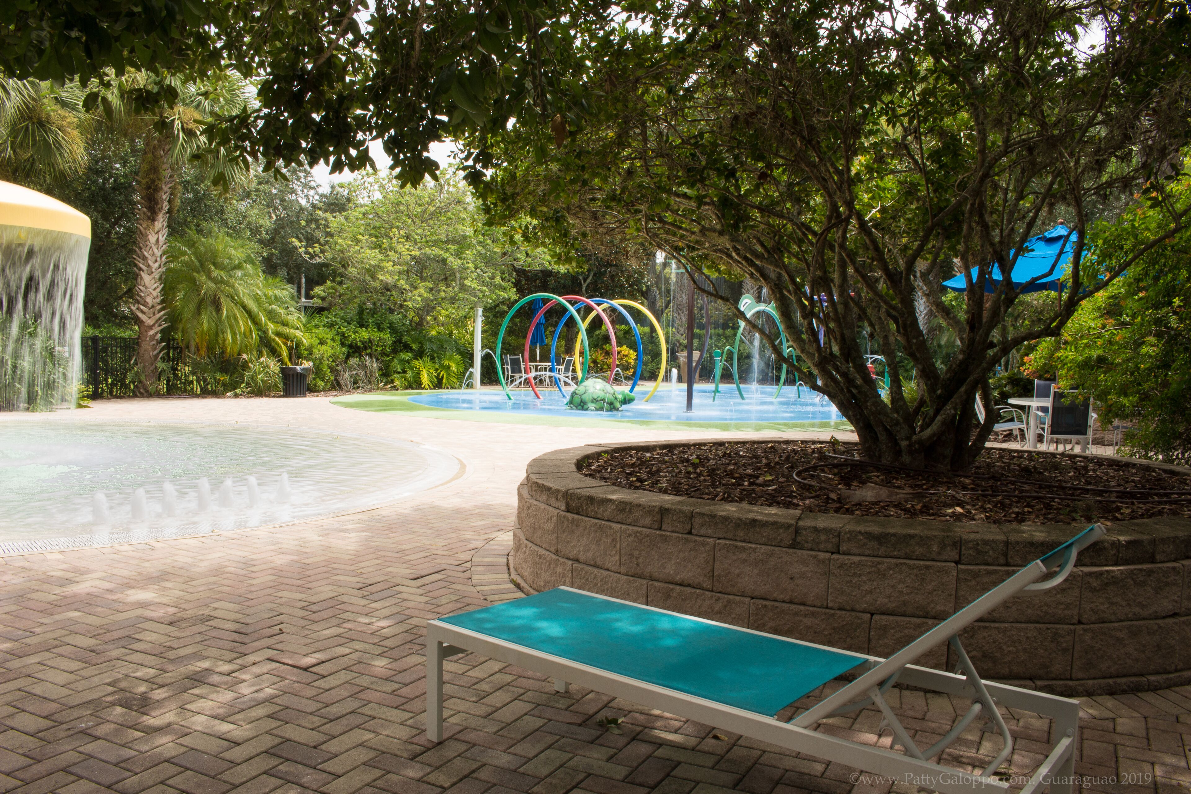 Un élément décoratif aquatique composé d’une fontaine circulaire et d’un banc.