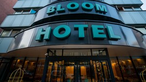 The exterior of the BLOOM HOTEL with a modern design and large signage. - Bloom Hotel (Ankara)