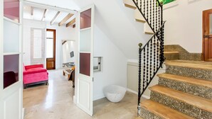 A staircase with a black balustrade leading to a landing. - Cozy town house with private swimming pool (Pollença)
