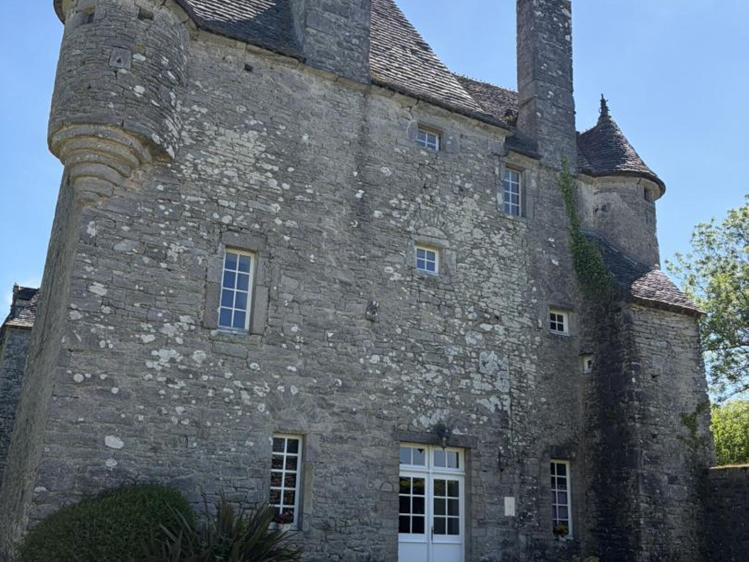 A stone castle with multiple towers and windows.