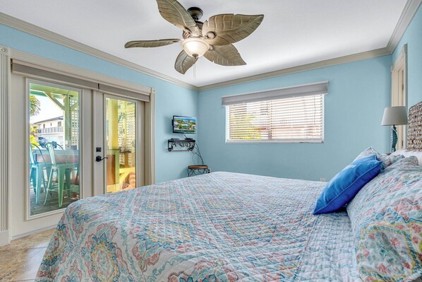 A bedroom with a bed, a ceiling fan, a TV, and a window with blinds. - P55 - Beautiful 3 bedroom, 3 bath home with private pool and hot tub. (Marathon)