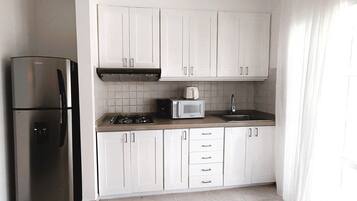 Fridge, coffee/tea maker, cookware/dishes/utensils, paper towels