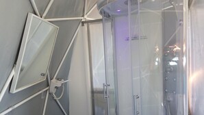 A modern bathroom with a glass shower enclosure, a mirror, and a towel rack. - Eremo di Montevergine : Seaview Dome, suspended between sky and sea (Forio)
