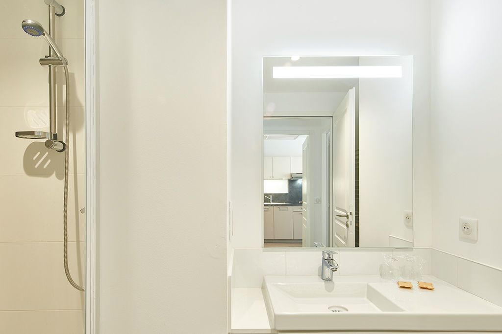 Freshen up at the sink and mirror, then rinse off in the shower