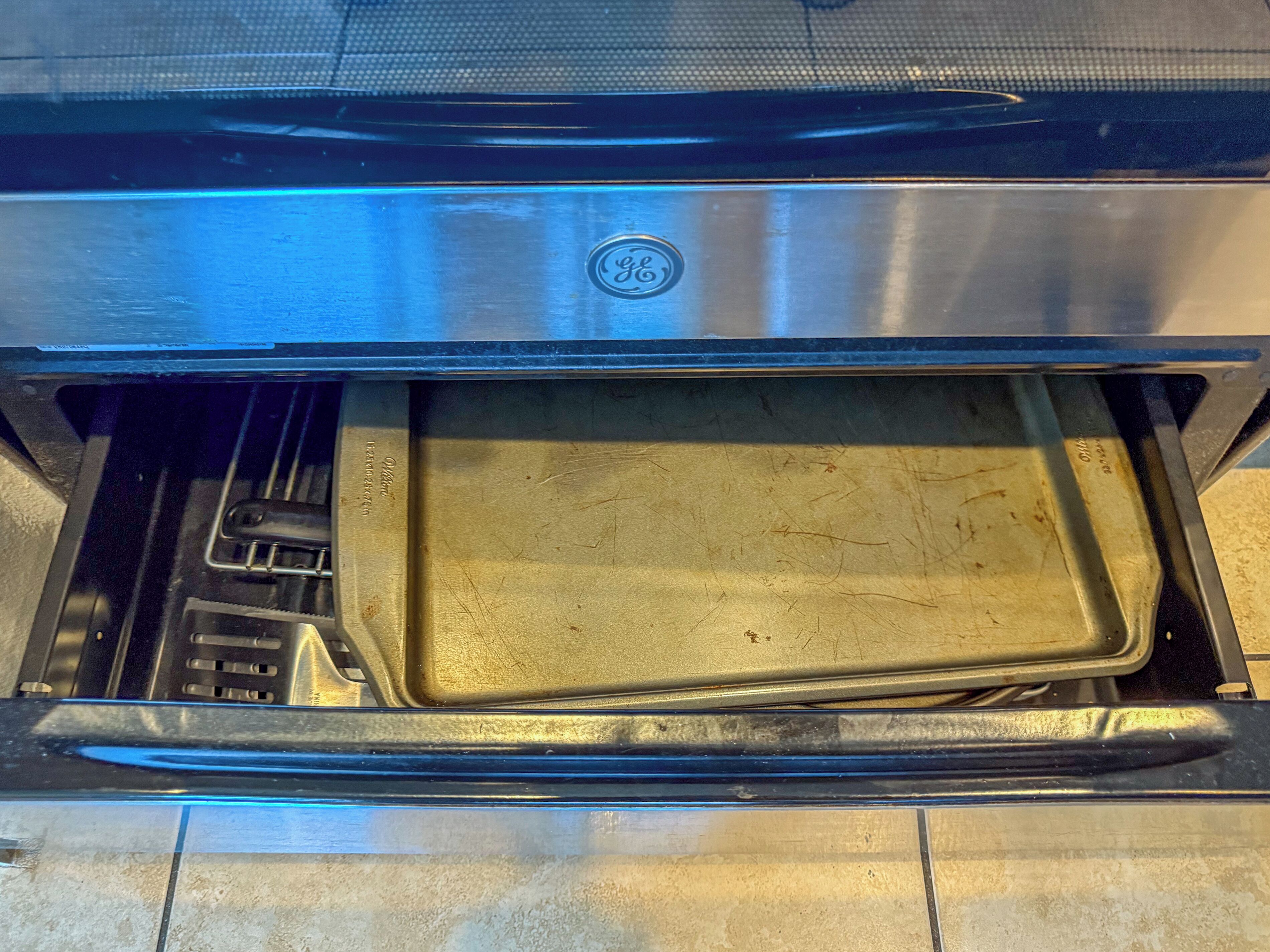 An open oven with a baking tray inside.