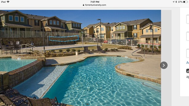 A residential area with a swimming pool, houses, and a 'No Diving' sign. - Apt for Sublease near TEEX (College Station)