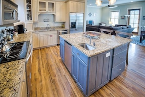 Kitchen Island, Stools, Refrigerator, and Coffee Table.