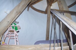 Traditional wooden structure with a wooden ladder and decorative accents.