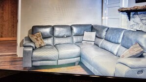 Un canapé modulable agrémenté d’un coussin décoratif à motifs et d’un coussin assorti posé sur l’accoudoir.
